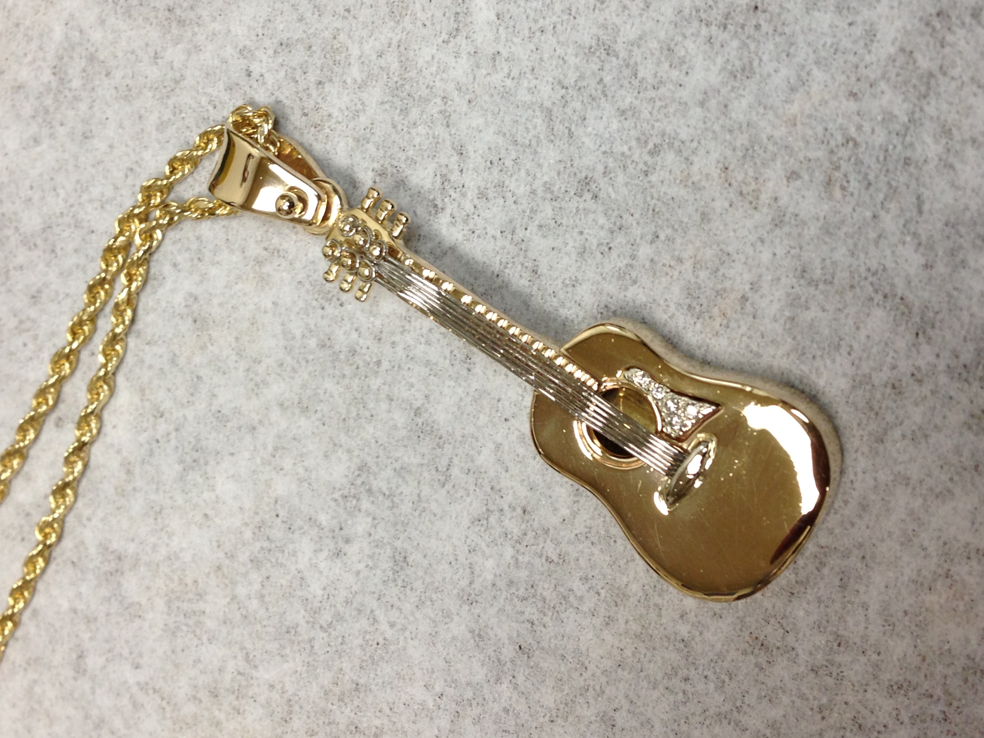 Custom designed 14Ktyewllow gold and platinum and diamond guitar pendant