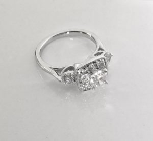Custom Designed Platinum and Diamond Three Stone Halo Ring
