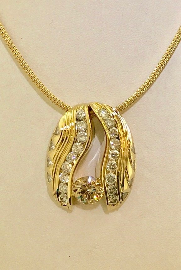 18KT Yellow Gold Custom Designed Pendant With Round Brilliant Full Cut Channel Set Diamonds, Trillion Cut Diamonds And  Large Diamond In The Center