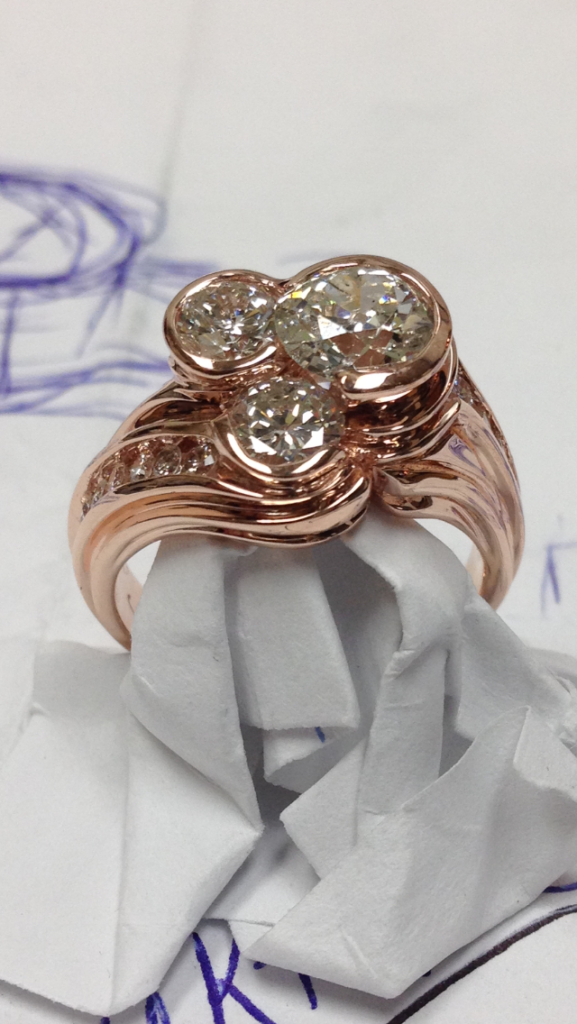 Custom Designed Rose Gold Three Stone Diamond Partial Bezel Set ring with Channel Set Diamonds